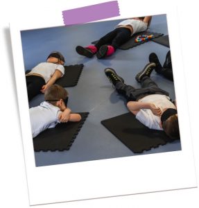 Children taking part in Mind Marvels class lying on mats