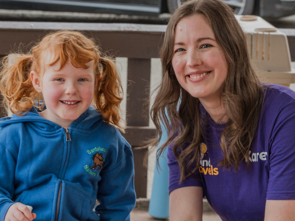Karen with little girl smiling at the camera