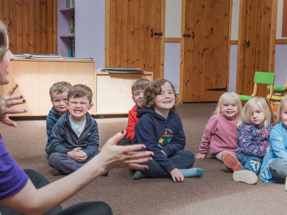 Karen speaking to children at a Mind Marvels session as the sit on the floor