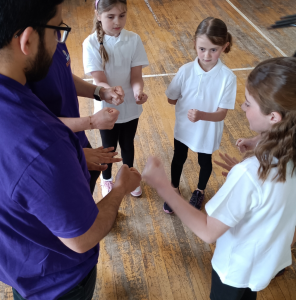 session leader with children in a circle playing game