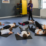 Angela with chime at Mind Marvels session while children are relaxing on their mats