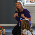 Angela smiling with children at Mind Marvels session